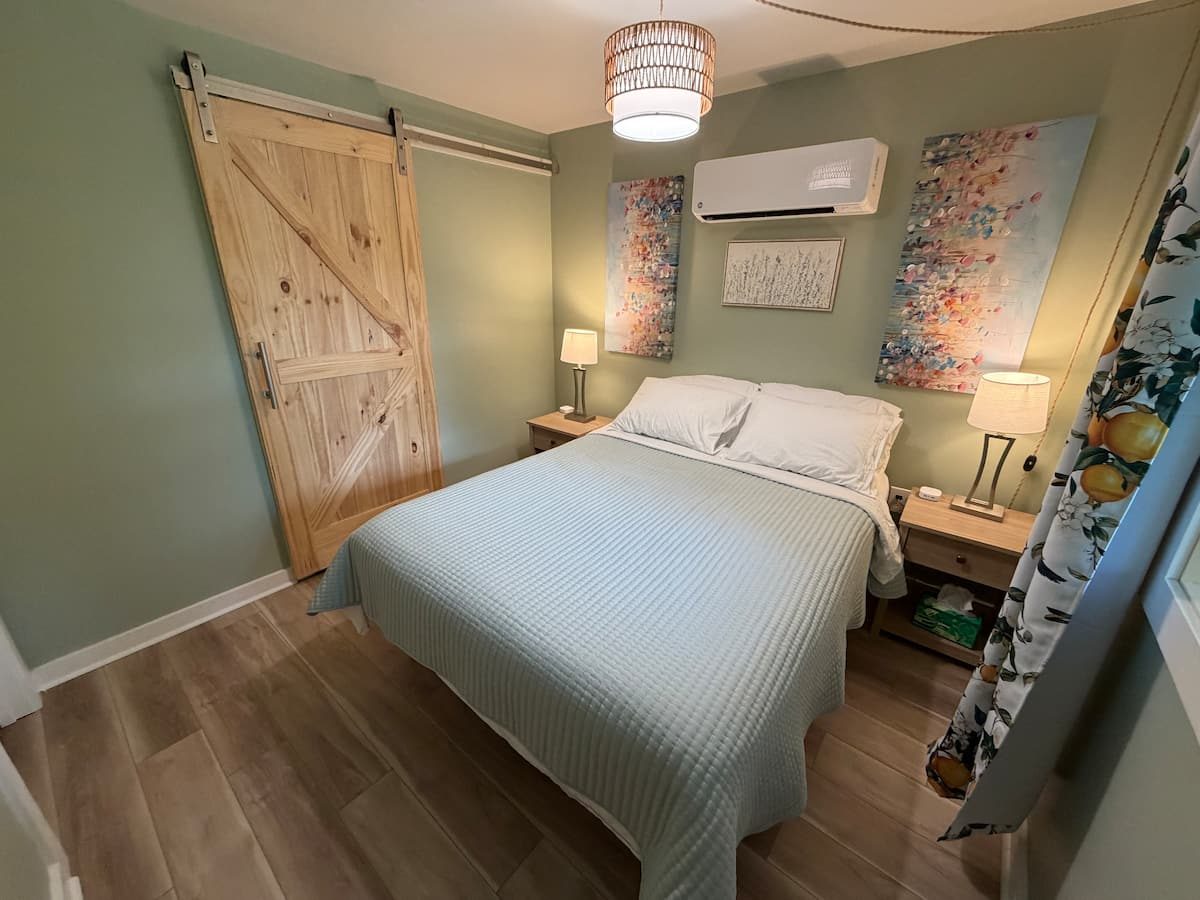 Bedroom with queen bed and sliding barn door